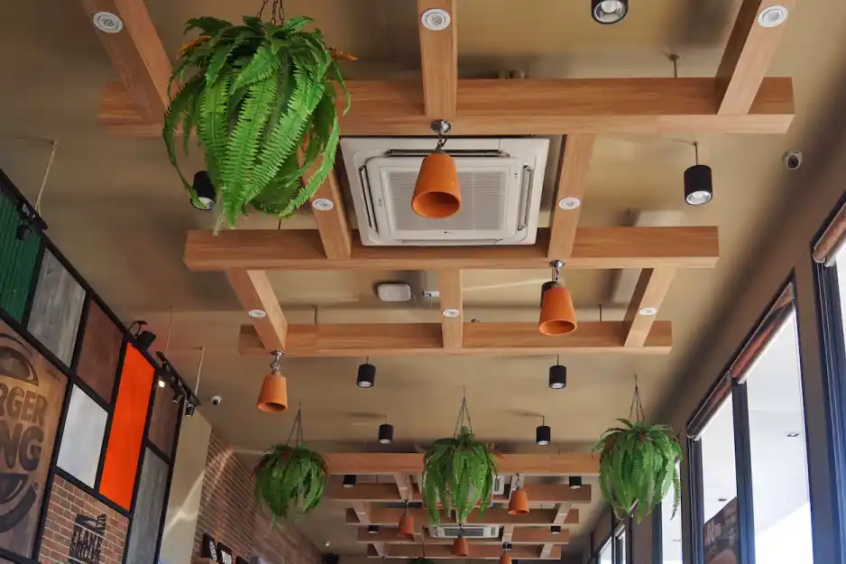 Ceiling-mounted cassette air conditioner in a stylish restaurant, maintaining optimal temperature for a restaurant.