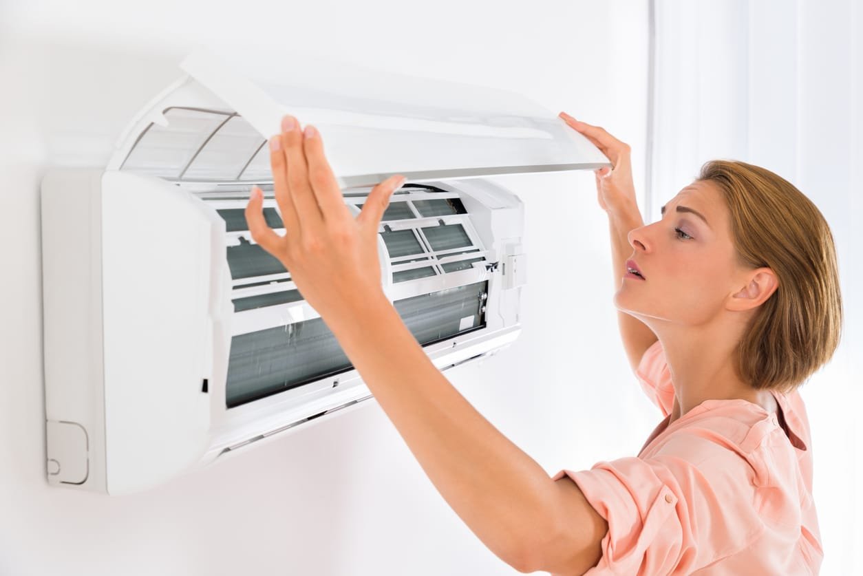 Young woman opens Daikin air conditioners at home