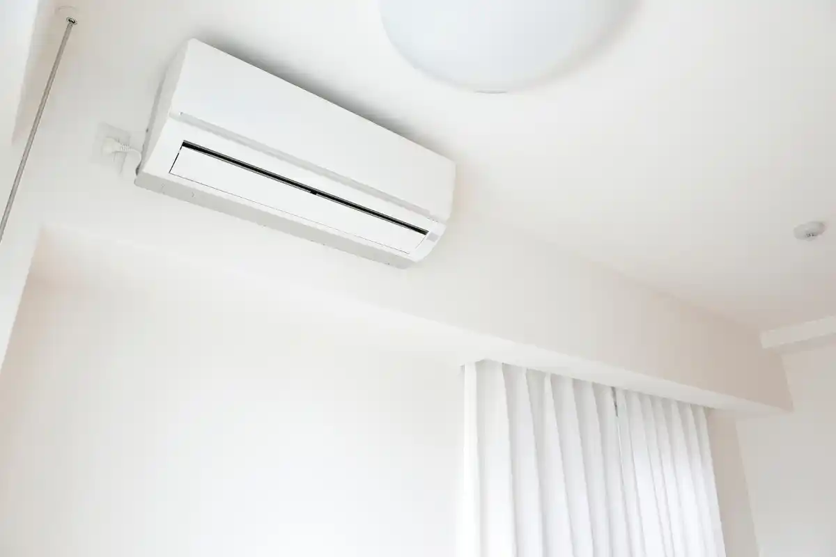 A sleek, white minimalist indoor AC unit demonstrating residential smart AI air conditioning technology systems.